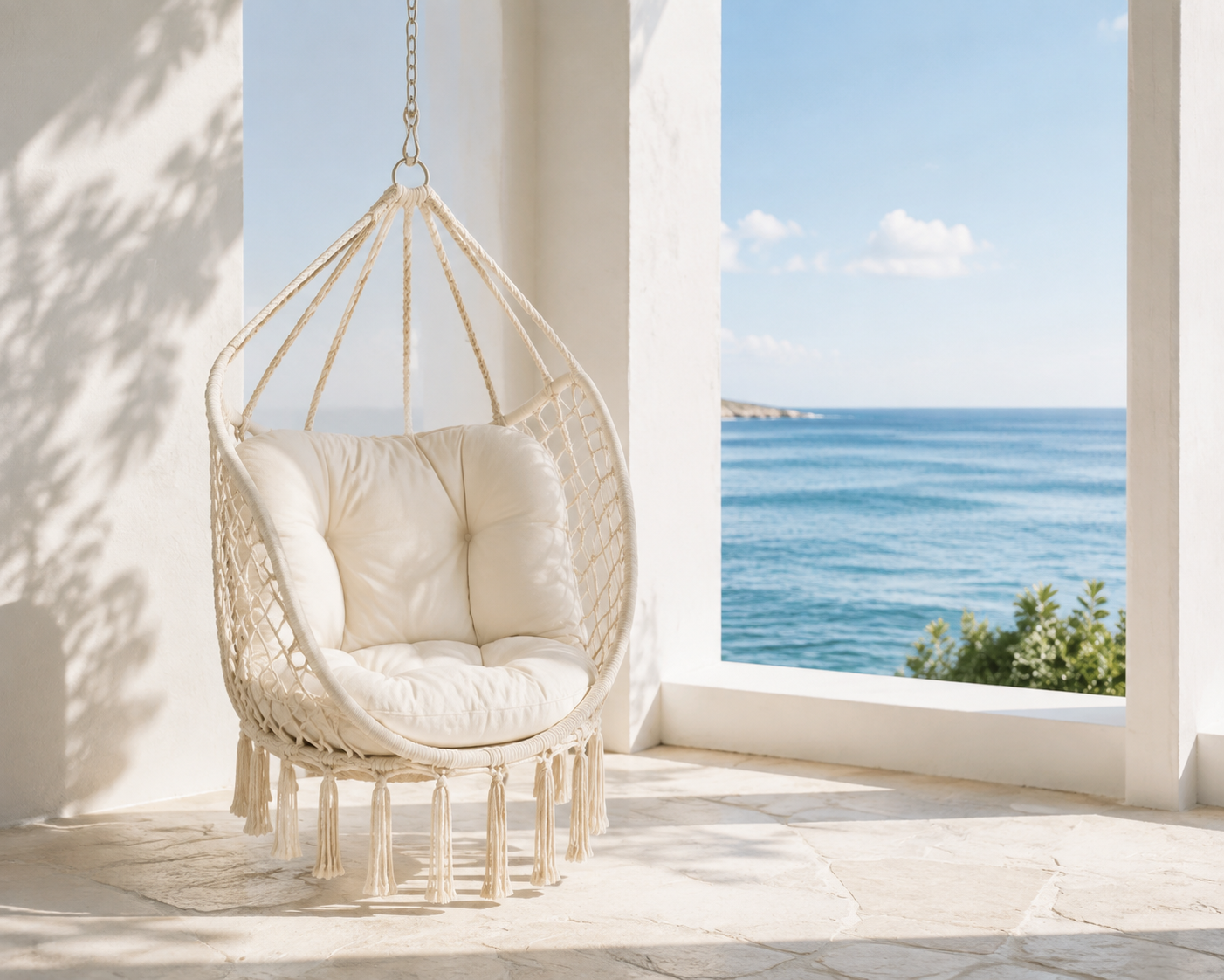 Cream SONGMICS hanging hammock chair styled on a bright coastal veranda